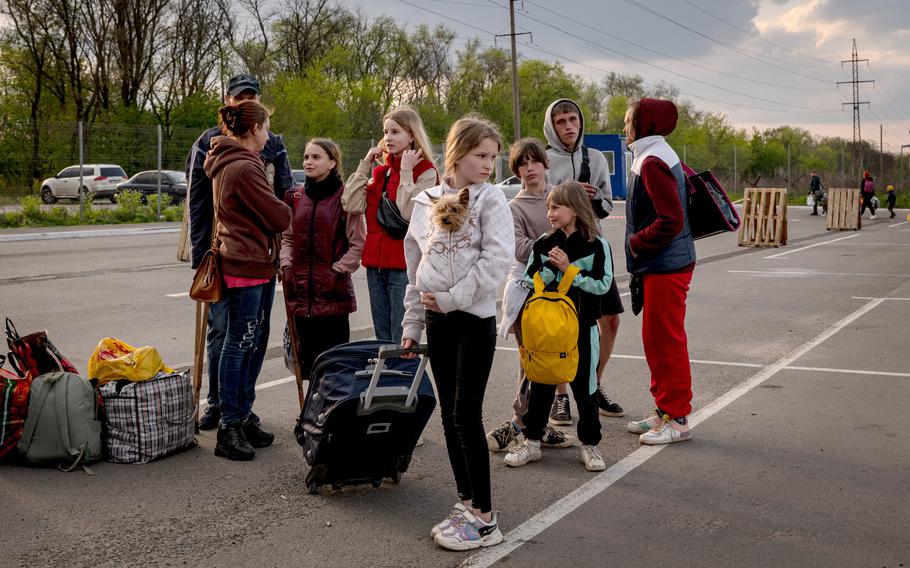 Families wait after being registered at a reception center for the internally displaced in Zaporizhzhia, Ukraine, on May 2, 2022.