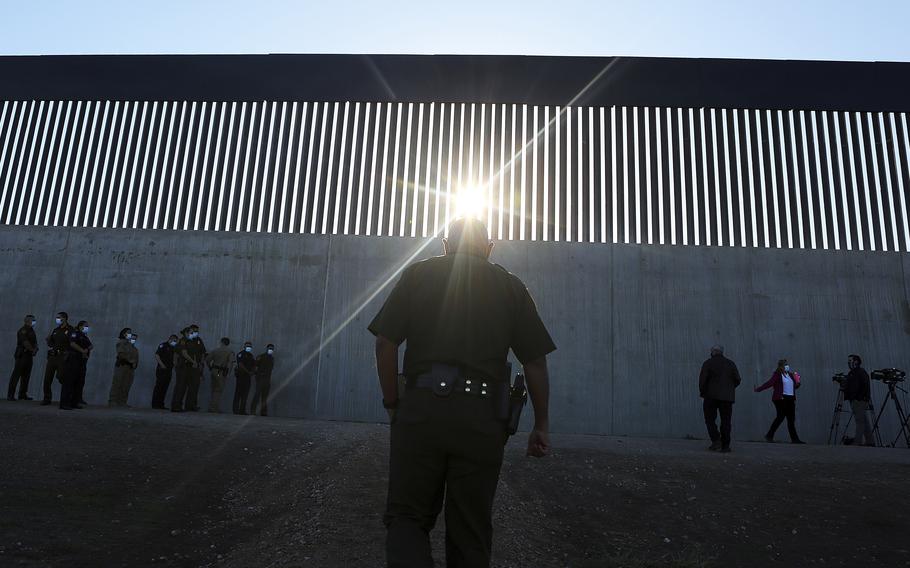 A U.S. Border Patrol agent walks up to a new section of the border wall before the arrival of Acting Homeland Secretary Chad Wolf, Thursday, Oct. 29, 2020, in McAllen, Texas. An investigation is underway after a Texas National Guard soldier allegedly shot and wounded a migrant during a struggle on the U.S-Mexico border this month.