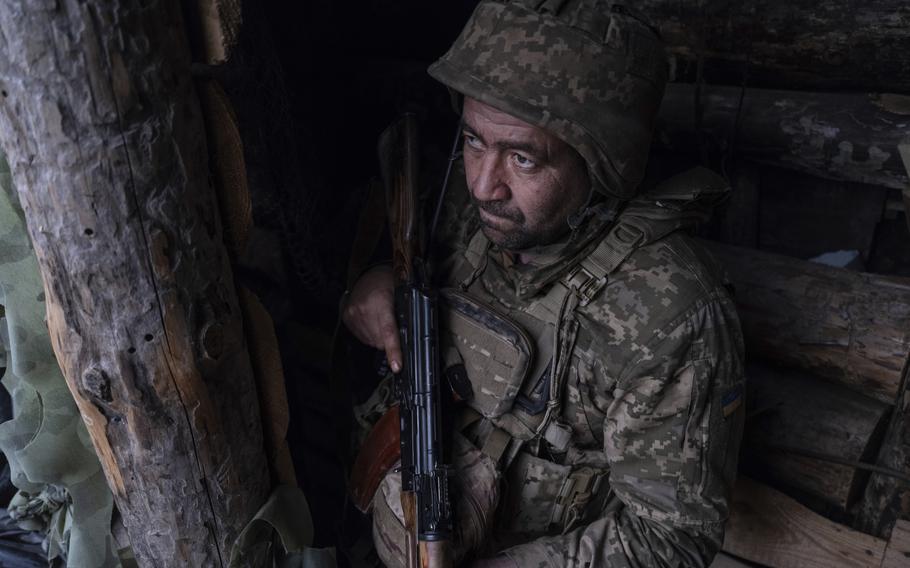 A soldier looks out of a shelter on the anti-drone firing position.