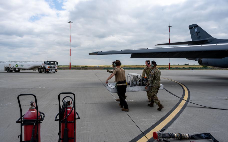 U.S. service members prepare to perform a hot-pit refuel on U.S. B-1B Lancers from the 7th Bomb Wing, Dyess Air Force Base, Texas, on June 12, 2023, at Kogălniceanu Air Base, Romania. Utilizing the Versatile Integrating Partner Equipment Refueling (VIPER) kit, maintainers refueled the aircraft with the engines running, allowing pilots to return to their mission rapidly.