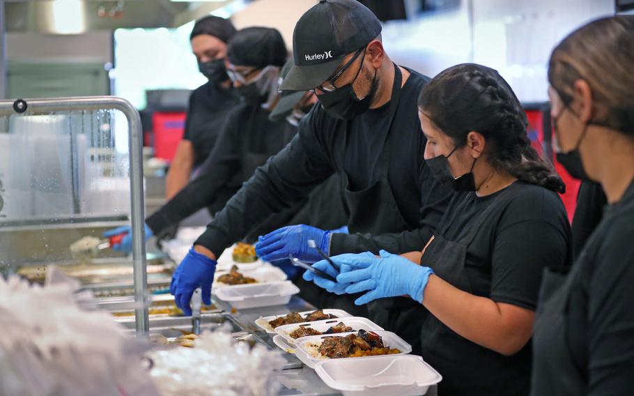 Food is readied for lunch in the dining hall as part of the Operation Allies Welcome program Thursday, Oct. 14, 2021, at Camp Atterbury in Edinburgh, Ind.