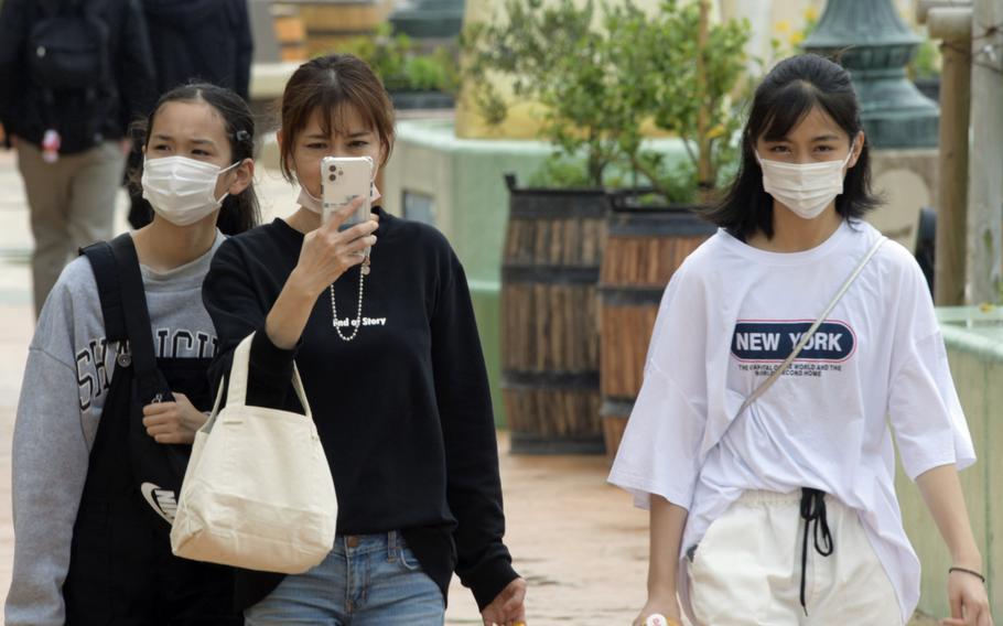 Visitors stroll through American Village, a tourist attraction on Okinawa, Japan, on March 30, 2022. 