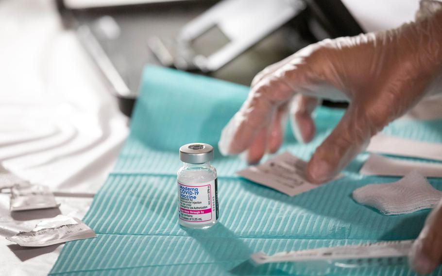 A healthcare worker prepares a dose of the Moderna coronavirus vaccine at the Brooklyn Children’s Museum vaccination site.