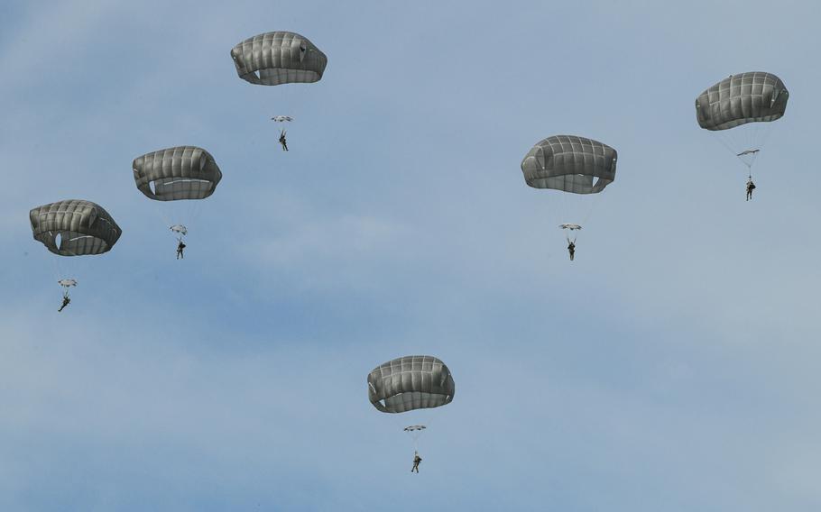 U.S. Army paratroopers from the 82nd Airborne at Fort Liberty, N.C., parachute out of a C-130J Super Hercules aircraft to secure the airfield in this small-scale seizure exercise demonstration during the Thunder Over the Rock Air Show at Little Rock Air Force Base, Oct. 21, 2023. 