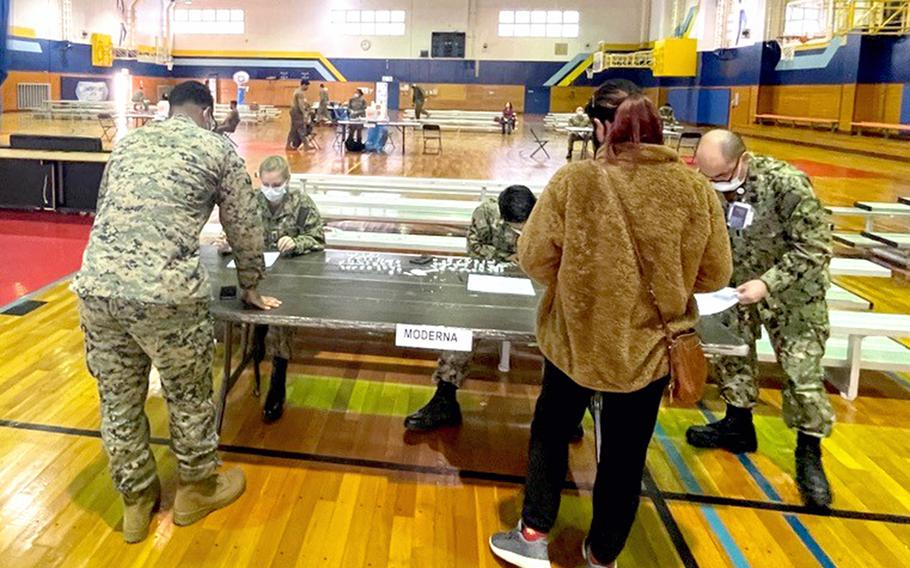 A vaccination clinic for the Moderna and Pfizer booster shots takes place inside the Iron Works gym on Marine Corps Air Station Iwakuni, Japan, Wednesday, Jan. 19, 2022.
