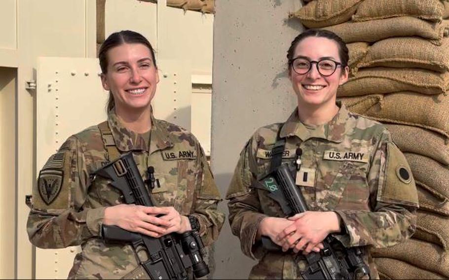 U.S. Army 1st Lt. Gina Decesare, left, and U.S. Army 1st Lt. Amelia Walker, who are assigned to the 37th Infantry Brigade Combat Team, speak to friends and family back home while mobilized in support of Operation Inherent Resolve.