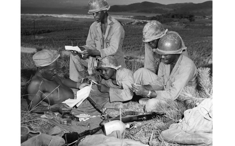 Soldiers reading letters.