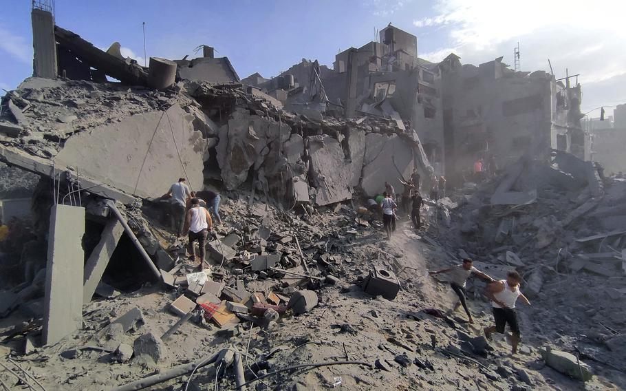 Palestinians inspect the damage of buildings destroyed by Israeli airstrikes on Jabaliya refugee camp on the outskirts of Gaza City on Oct. 31.