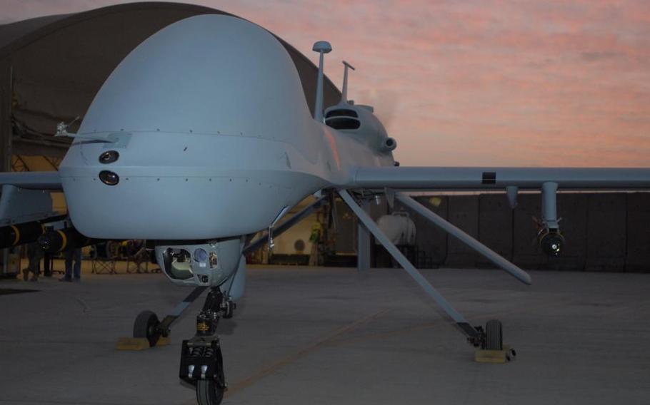 An MQ-1C Gray Eagle armed with Hellfire missiles revs up before taking flight at Camp Taji, Iraq, in 2011. 