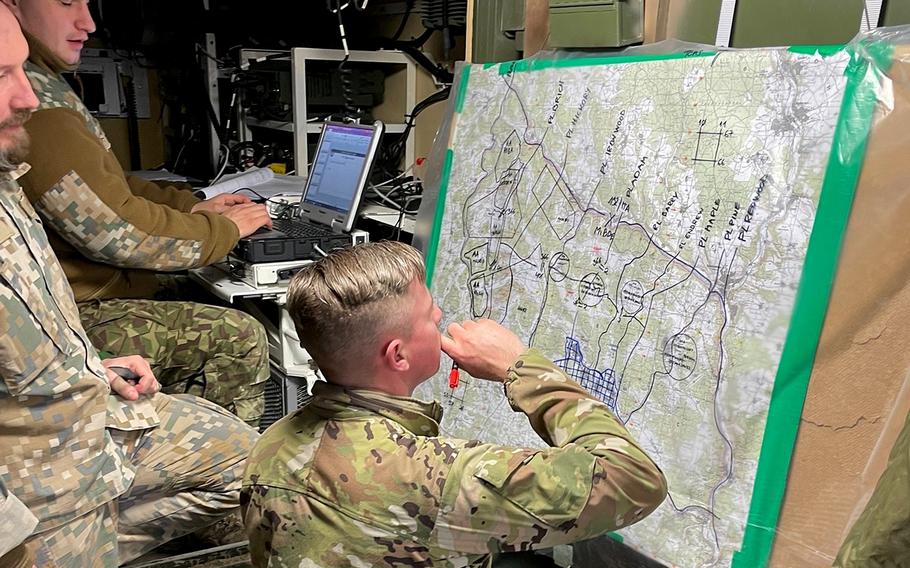 U.S. Army Sgt. 1st Class Matthew Hugelmann, an adviser assigned to the 4th Security Forces Assistance Brigade, works with Latvian soldiers during exercise Allied Spirit in Hohenfels, Germany, on Jan. 28, 2022. 