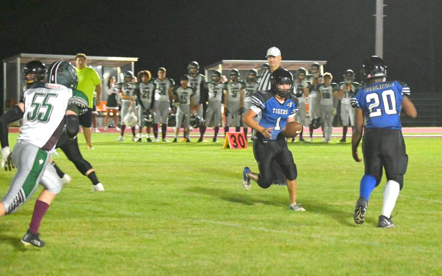 Hohenfels’ Preston Mitchell Hands it off to running back Trashon Fortenberry for Hohenfels’ only touchdown of the game on a run outside of the numbers on the right side of the field during a football game against the AFNORTH Lions on Sept. 29, 2023 at Hohenfels Middle High School.