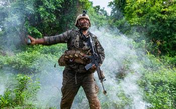 U.S. Army Spc. Lavarias Kawika, an infantryman assigned to the 100th Infantry Battalion, roleplaying as opposing forces throws a smoke grenade during a simulated engagement as part of the Joint Pacific Multinational Readiness Center-Exportable exercise at Fort Magsaysay, Philippines, June 7, 2024. 