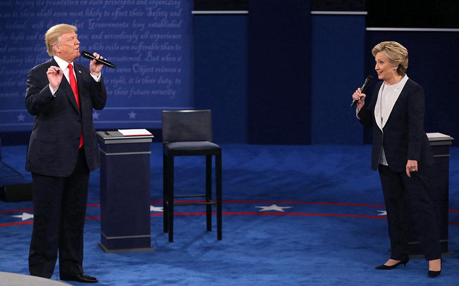 Donald Trump and and Hillary Clinton are on stage during the second debate between the Republican and Democratic presidential candidates on October 9, 2016, at Washington University in St. Louis. Trump announced on Thursday, March 24, 2022, that he is suing Clinton over the “Russia hoax.”
