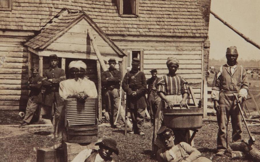 Laundresses with Union soldiers, circa 1863. 