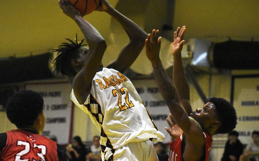 Kadena's Jaylen Allen shoots against Kinnick's Xavier Wright.