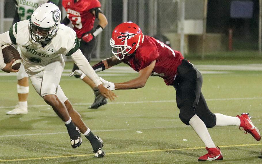 Kubasaki's Trajon Weaver tries to outrun Nile C. Kinnick's Michael Torres.