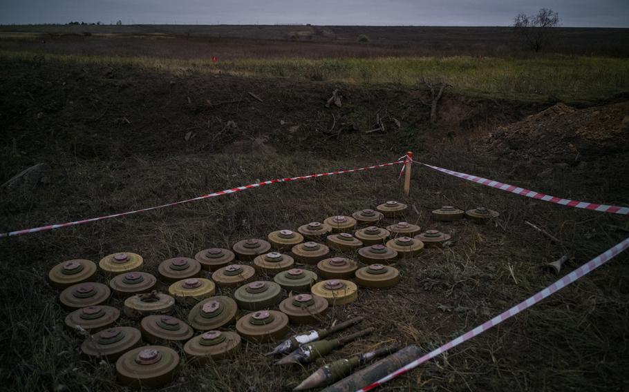 Mines and unexploded rockets next to a destroyed bridge on the way to Kherson, Ukraine, in November 2022. MUST CREDIT: Photo for The Washington Post by Wojciech Grzedzinski.