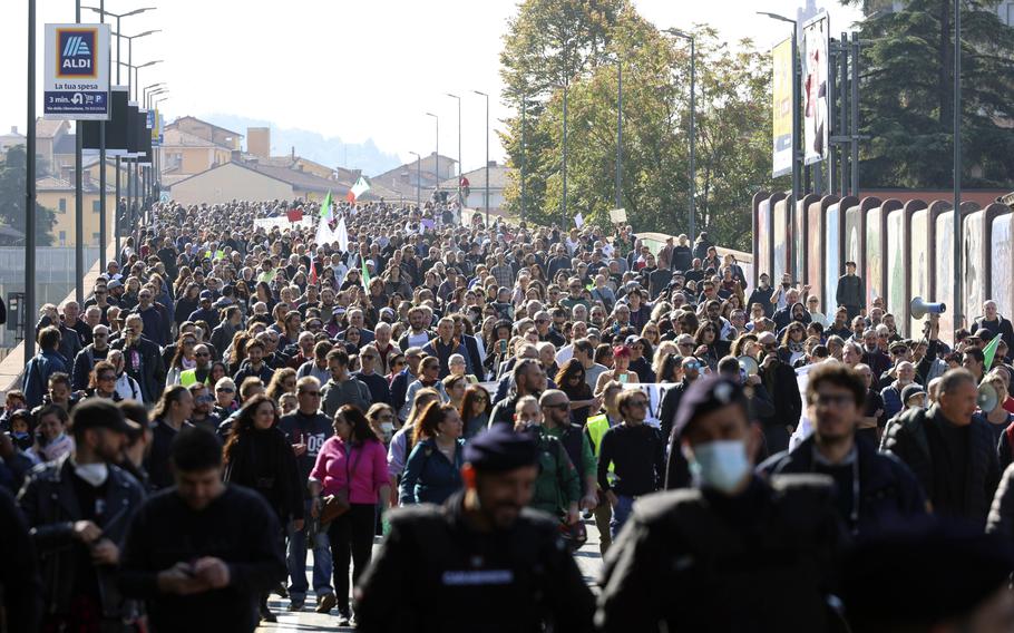 People march during a protest against the COVID Green Pass in Bologna, Italy, Friday, Oct. 15, 2021. 