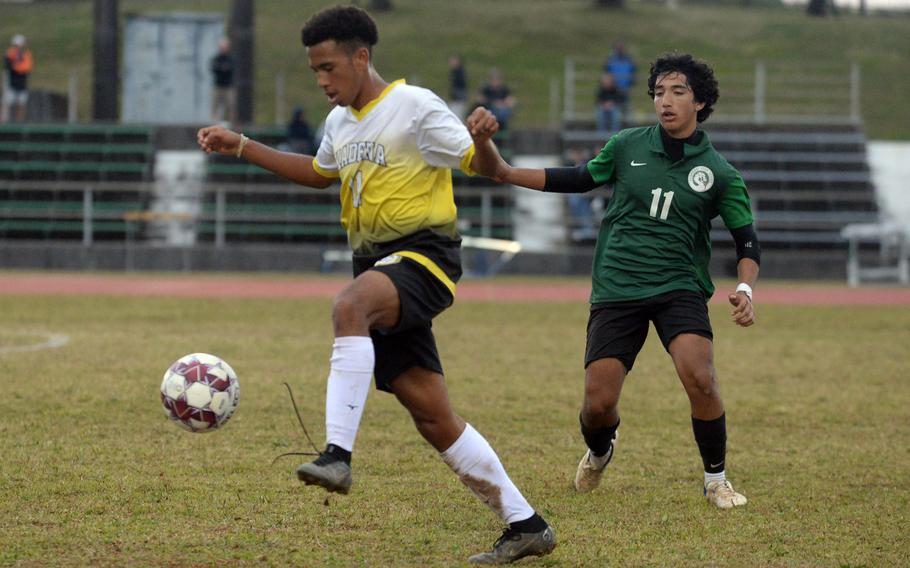 Kadena's Yoshua Whipp tries to settle the ball in front of Kubasaki's Aiden Oshana during Wednesday's Okinawa boys soccer match. The Panthers won 3-2.
