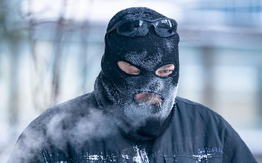 Charles Zajicek uses a power sweeper to clear snow off the sidewalk Thursday, Dec. 22, 2022, in downtown Minneapolis. The Twin Cities saw 8 inches of snow Wednesday followed by wind gusts up to 50mph and windchills reaching -35 degrees F on Thursday and Friday. 