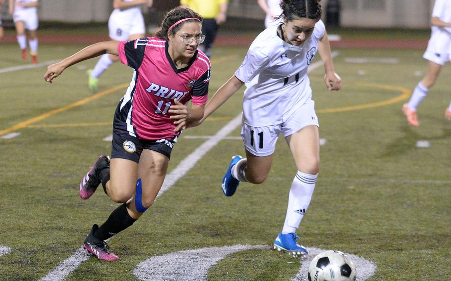 Kadena's Emmah Strong and Zama's Lindsay So chase the ball during Friday's All-DODEA-Japan soccer tournament quarterfinals. The Panthers edged the Trojans 1-0.