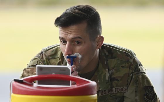 An airman shaves his mustache during an event at Joint Base Lewis-McChord, Wash., March 31, 2023.