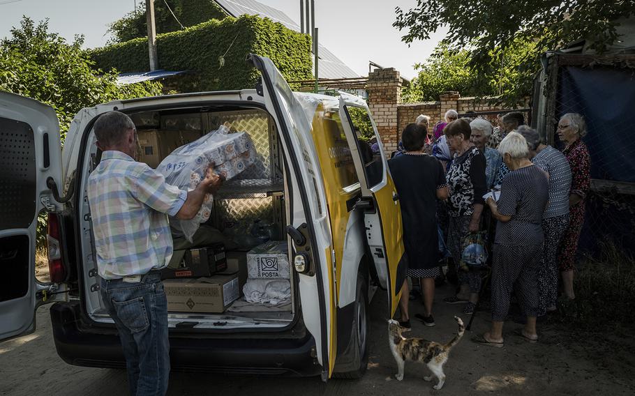 Postal workers bring pension checks, letters and packages to a village in the Mykolaiv region on July 15., 2022.