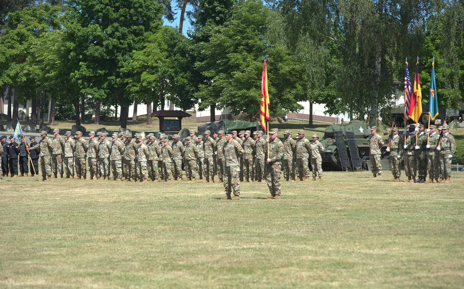 Troops stand at attention on the parade ground.