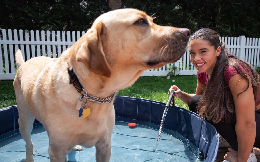 Anastasia Pagonis, who lost her vision at age 14, with her service dog, Radar, outside of her home in Garden City, N.Y., on Aug. 10. Pagonis participated in the Paralympics in Tokyo. 