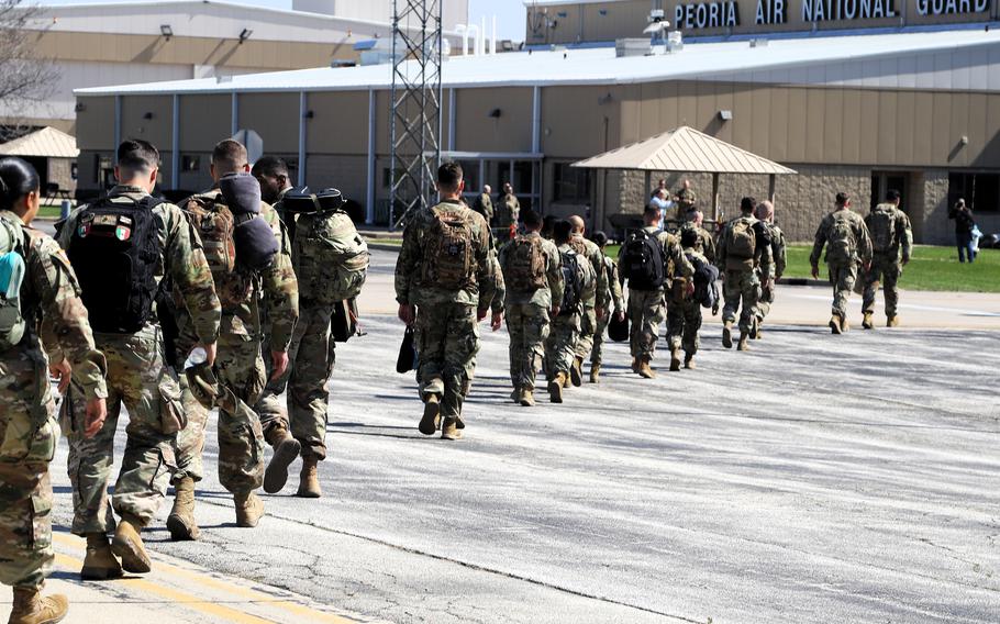 Soldiers disembark an airplane
