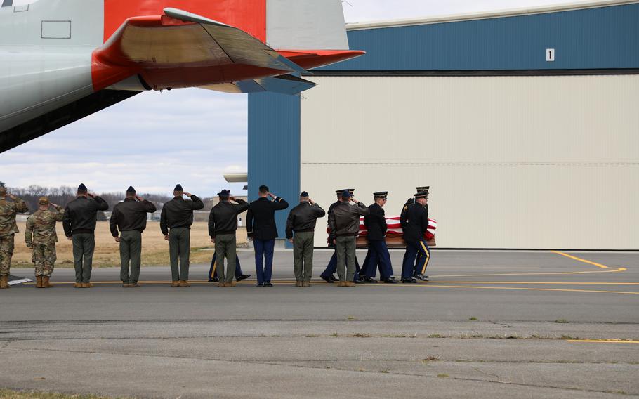 New York Air National Guard soldiers and airmen salute as a New York Army National Guard Honor Guard team carries the remains of Chief Warrant Officer 2 Casey Frankoski from a 109th Airlift Wing LC-130 to a waiting hearse at the Army Aviation Support Facility in Latham, N.Y., on Monday, March 18, 2024. 