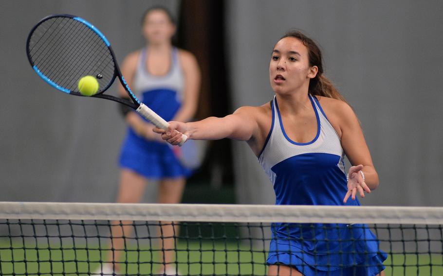 Wiesbaden's Hope Goodwin hits a winner at the net against Ramstein in the girls doubles final at the 2019 DODEA-Europe tennis championships in Wiesbaden, Germany.  Goodwin will return for the Warriors when the 2021 tennis season gets underway.