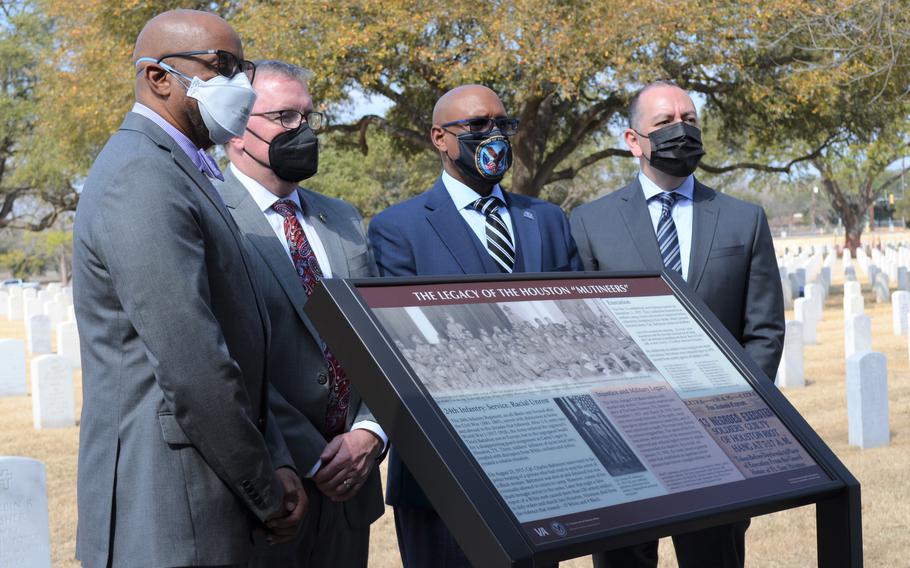 From left, Jason Holt, nephew of a soldier executed in 1917, Matthew Quinn, undersecretary for memorial affairs with the Department of Veterans Affairs, Donald Remy, deputy secretary of VA, and Gabe Camarillo, undersecretary of the Army, stand Tuesday at a newly unveiled sign to commemorate the history of 17 soldiers buried at Fort Sam Houston National Cemetery in San Antonio after they were executed for their role in a race riot in Houston in 1917. The sign acknowledges the trials of the soldiers were “flawed by serious irregularities.”