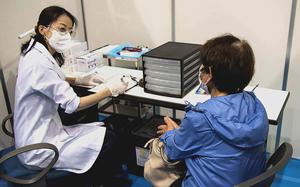 A woman checks in at a COVID-19 vaccination site in Yokohama, Japan, May 17, 2021.

