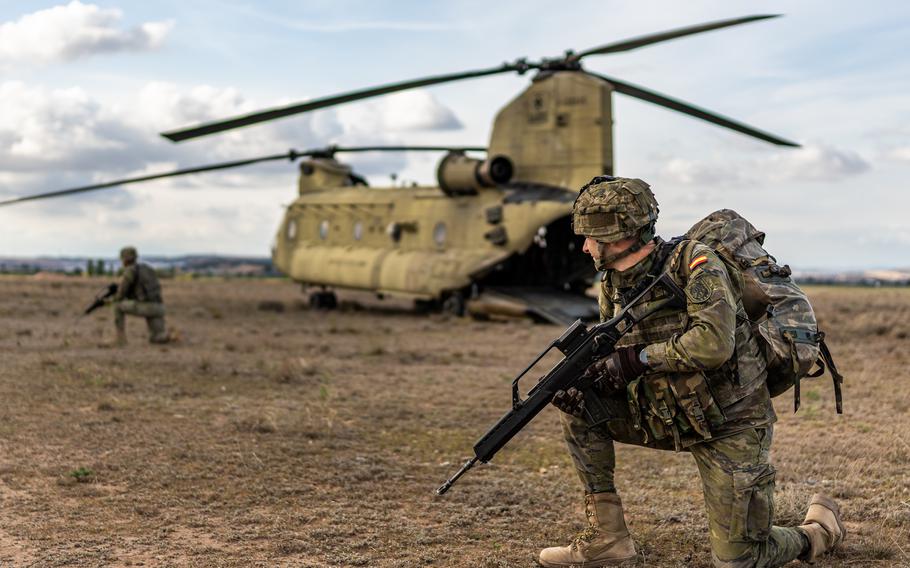 Spanish soldiers secure the perimeter of a U.S. Army CH-47 Chinook during Defender Europe 2023 at Zaragoza Air Base, Spain, May 15, 2023. NATO ramped up defense spending in 2023 as more members hit a key fiscal target, NATO Secretary-General Jens Stoltenberg said July 7, 2023.