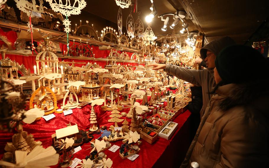 Shoppers looks at holiday displays at the Christmas Market in Stuttgart, Germany, Dec. 7, 2012. 