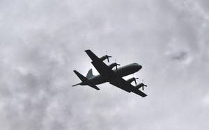 A Taiwan air force C-130 flies overhead.