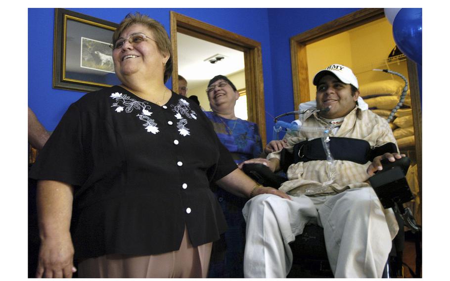 Mother Emilia Gomez and friend Lucy Seda tour Sgt. Joel Gomez’s new bedroom at his accessible home in Wheaton, Illinois, on Sept. 2, 2005.
