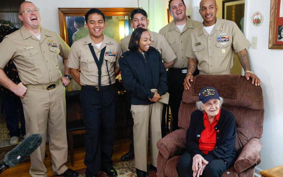 Sailors from the USS Fort Worth laugh with Navy World War II veteran Elsie Kitty Rippin