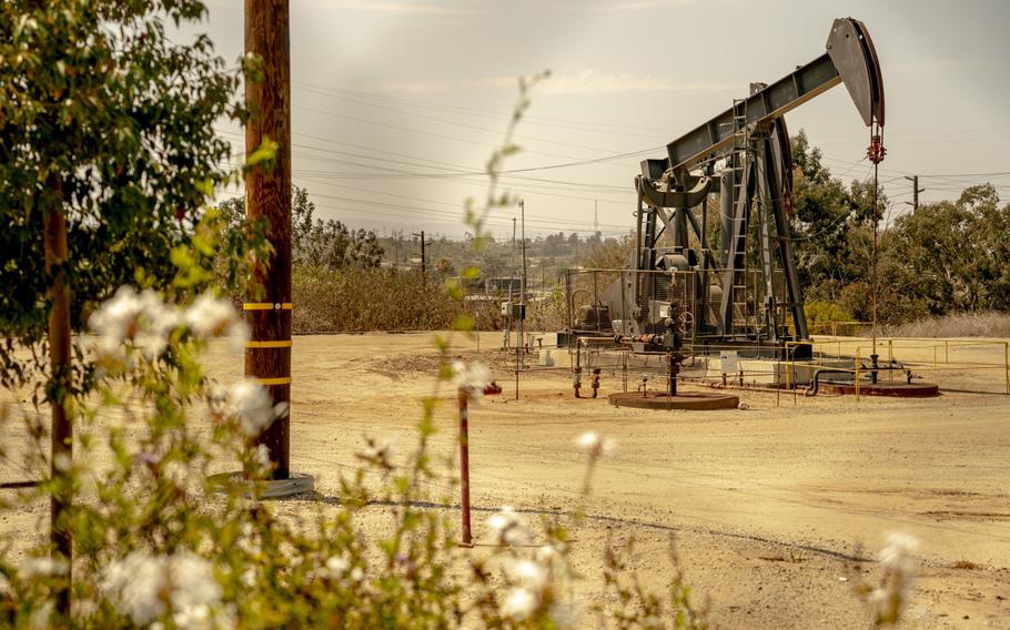 An oil derrick pump operates at the Inglewood Oil Field in Culver City, Calif., on July 11, 2021. 