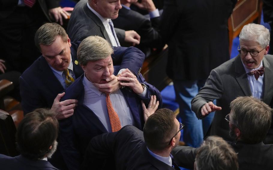 Rep. Richard Hudson, R-N.C., left, pulls Rep. Mike Rogers, R-Ala., back as they talk with Rep. Matt Gaetz, R-Fla., and other during the 14th round of voting for speaker as the House meets for the fourth day to try and elect a speaker and convene the 118th Congress in Washington, Friday, Jan. 6, 2023. At right is Rep. Patrick McHenry, R-N.C.