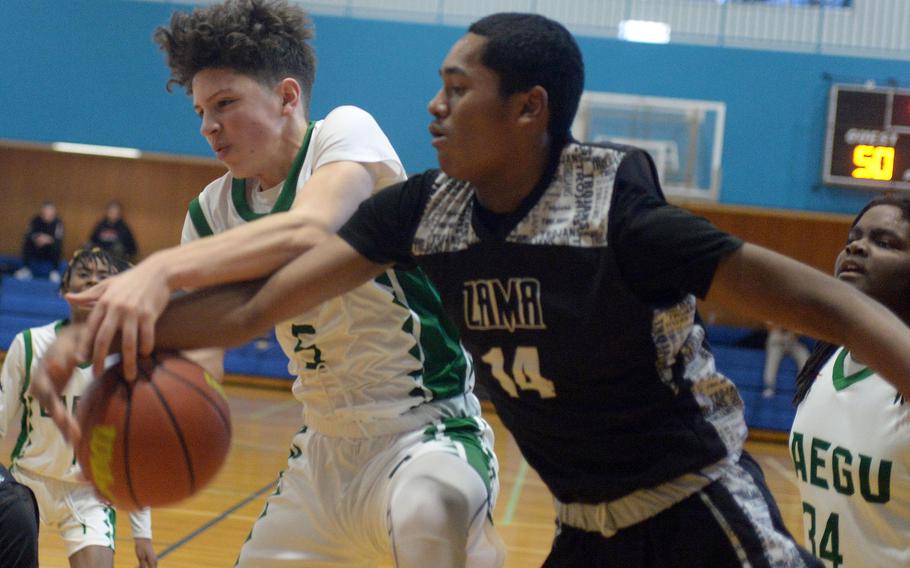 Daegu's Jude Velazquez and Zama's Derek Smith battle for a loose ball. The Trojans won 65-61.