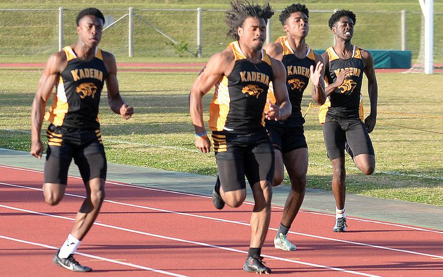 Kadena’s D’Kylan Woods leads three teammates down the stretch of the 100 during Thursday’s Day 2 of the two-day Okinawa track and field meet. Woods won in 10.88 seconds.