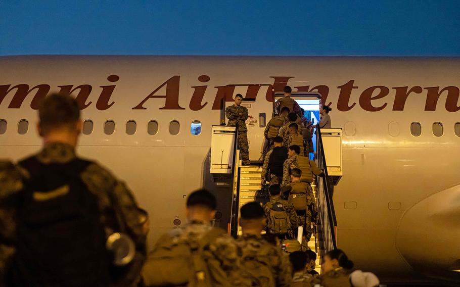 After six months Down Under, members of Marine Rotational Force - Darwin board a homebound Boeing 777 at Royal Australian Air Force Base Darwin in Australia's Northern Territory, Oct. 01, 2023.