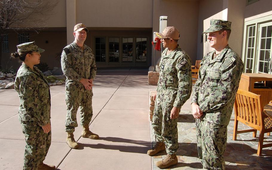 Hospital Corpsman 2nd Class Jessika Gomez, left, Hospital Corpsman 2nd Class Brian Rice, Cmdr. Nikunj Bhatt and Lt. Bob Geis of the Naval Medical Readiness Training Command team out of San Diego converse in the garden at San Juan Regional Medical Center on Dec. 11, 2021.