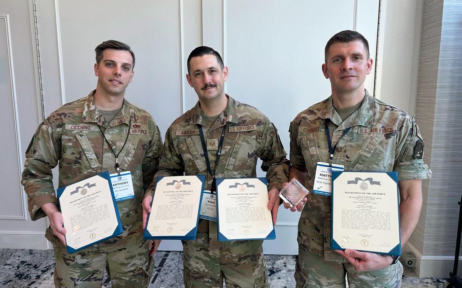 Air Force Staff Sgt. Ryan Amador, center, poses with his Project Weapon team at the Aether Sprint innovation competition in St. Louis, March 28, 2024.