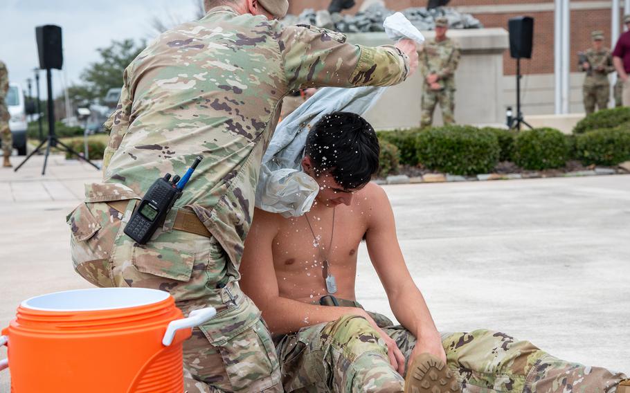 Soldiers with the Army’s 4th Airborne and Ranger Training Brigade demonstrate ice sheeting to rapidly cool a service member experiencing a suspected heat injury during the Army Heat Forum at Fort Moore, Ga., on Wednesday, Feb. 28, 2024. 
