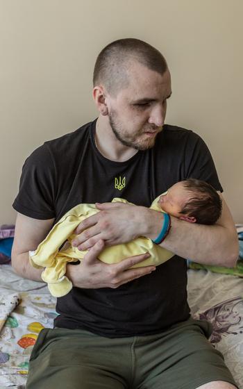 Ivan Soroka, a Ukrainian veteran who lost sight in both eyes because of combat injuries, on Monday, April 29, 2024, holds his newborn son Sviatoslav, born three days earlier.