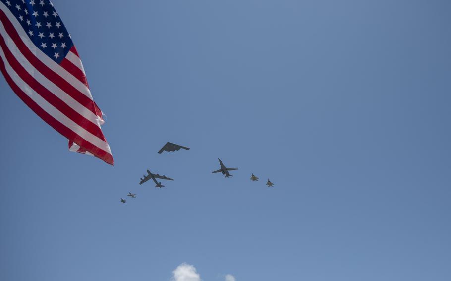 A U.S. Air Force B-2 Spirit leads a seven-ship dissimilar formation ahead of a flyover 