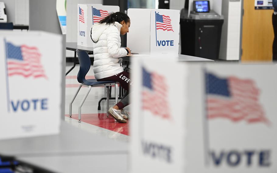 A voter fills out a ballot at George C. Marshall High School on Nov. 2, 2021, in Falls Church, Va. M